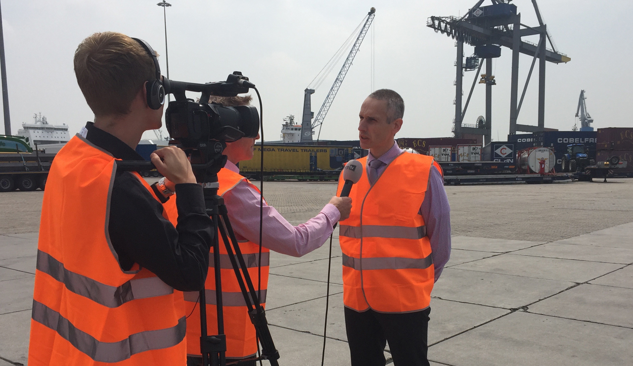 Crisis communication training. TV reporter questions spokesman on location at the Port of Rotterdam.